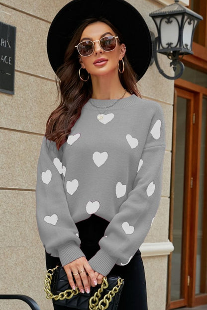 Suéter tipo túnica con cuello redondo y mangas abullonadas con estampado de corazón tejido a la derecha
