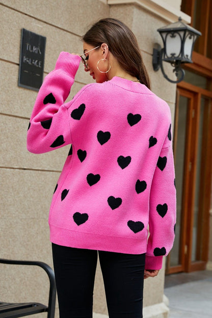 Suéter tipo túnica con cuello redondo y mangas abullonadas con estampado de corazón tejido a la derecha