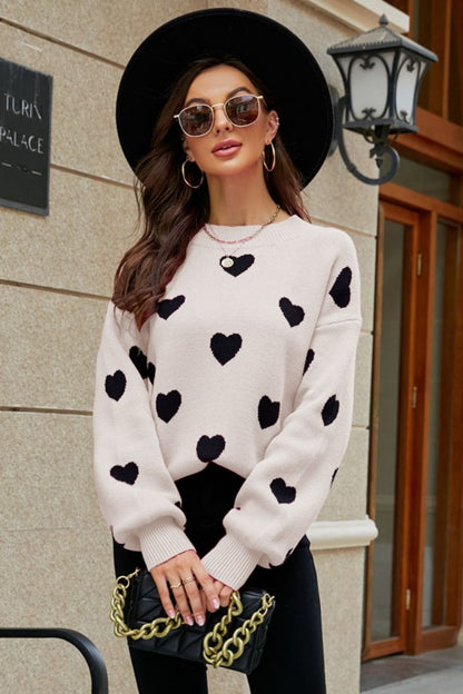 Suéter tipo túnica con cuello redondo y mangas abullonadas con estampado de corazón tejido a la derecha
